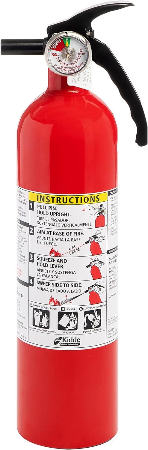 Red emergency fire extinguisher ready for use in case of a fire.